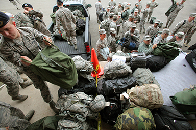 Airmen of the New Jersey National Guard's 108th Wing are processed in at Joint Base McGuire-Dix-Lakehurst, N.J., before being sent out to assist at various emergency shelters prior to the landfall of Hurricane Sandy, Oct. 28, 2012.